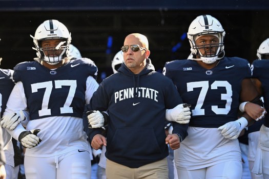 Penn State football coach James Franklin is flanked by offensive linemen Sal Wormley, left, and Caedan Wallace as the Nittany Lions take the field before Saturday’s win over Rutgers. (AP Photo/Barry Reeger)